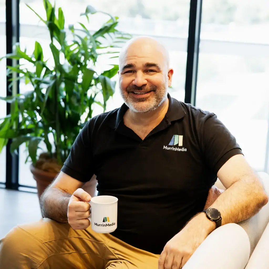 David today, smiling with a coffee mug
